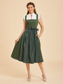 Abito Dirndl verde tinta unita da donna con grembiule lucido e fiocco
